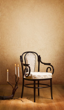 vintage chair and candles in the dark room with space for text