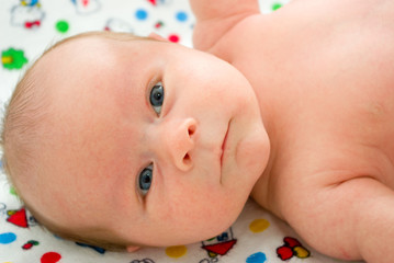 Newborn boy with grey eyes  laying on a blanket - 76887391