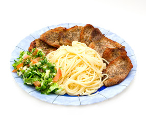 Spaghetti with fried pork fillet and fresh vegetables salad
