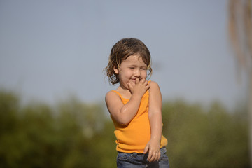 little toddler girl playing and dancing in the summer rain
