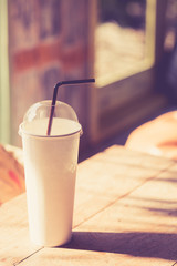 Coffee cup on wood, vintage color