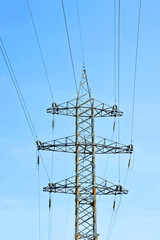 Electric lines pylon on blue sky background