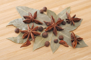 bay leaf, allspice, and star anise on a wooden table
