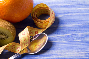 Fruits with measuring tape with wood background