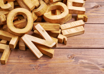 Pile of wooden letters over the wooden surface