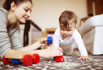 Little baby girl playing with her mother