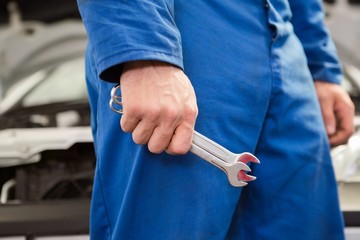 Mechanic standing with wrench in hand