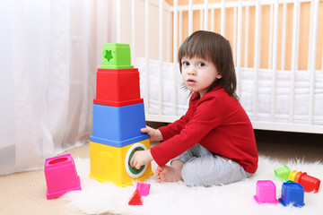 2 years toddler playing with educational toy