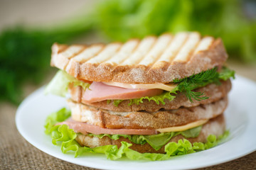 sandwich with sausage, cheese and herbs