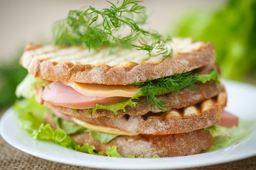 sandwich with sausage, cheese and herbs