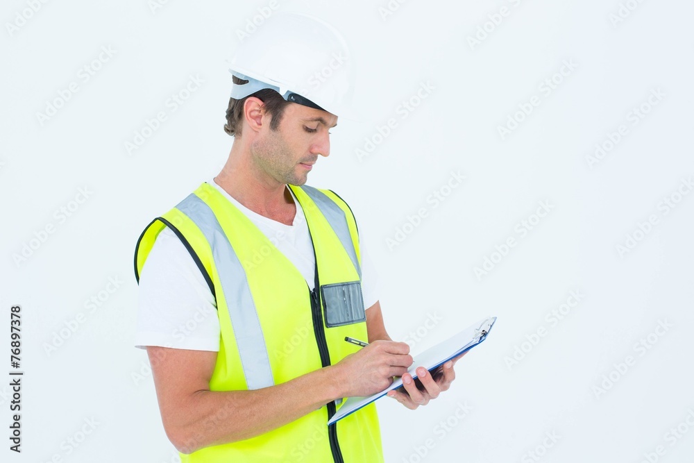 Poster worker writing notes on clipboard