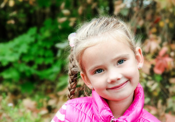 Autumn portrait of cute smiling little girl