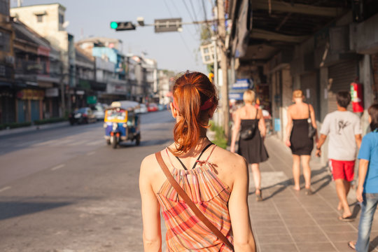 Woman walking in the street in Asia