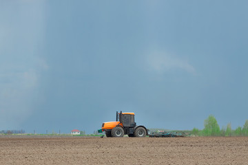 Obraz premium Tractor cultivating the field