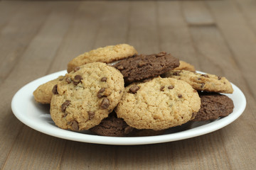 chocolate chip cookies on a plate on a wooden background