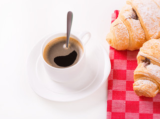 Breakfast with coffee and croissants on table