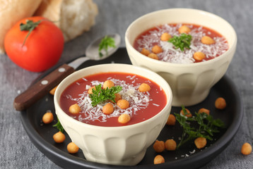 Fresh tomato soup with parmesan and croutons in a white bowl