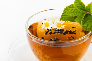Glass Cup Tea with Mint Leaf and camomile flower Isolated on Whi