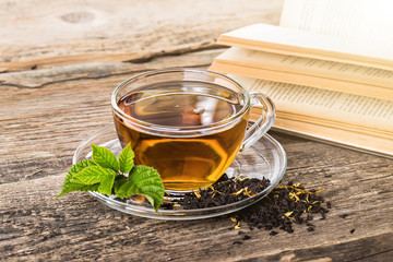 Glass Cup Tea with and Mint Leaf, on brown wooden palette