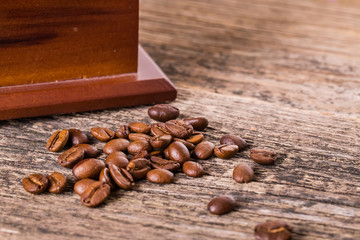coffee beans and old coffee mill in shop, cafe on wooden table