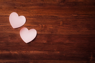 Fototapeta premium Sticky notes in the form of hearts on vintage wooden background