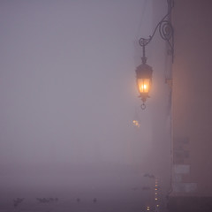 Lantern on market square in Krakow at morning fog