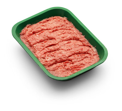 Raw minced meat in a green tray over white background
