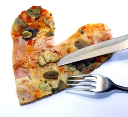 slice of pizza in the shape of a heart with a knife