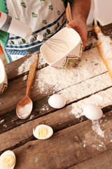 close up of male hand whisking something in a bowl