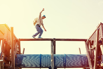 traveler walking balance over top of wooden construction
