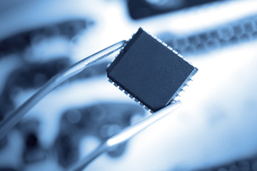 computer chip with tweezers, electronic