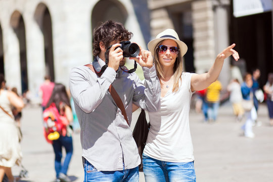 Couple of turists taking picture in the city