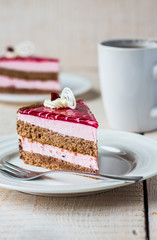 piece of cake with a chocolate biscuit, berry mousse and jelly
