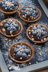 chocolate mousse with fresh blueberries and nuts in tartlets