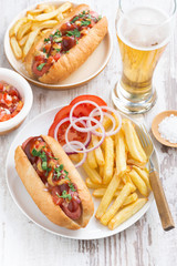 fast food - hot dog with French fries, beer and snacks