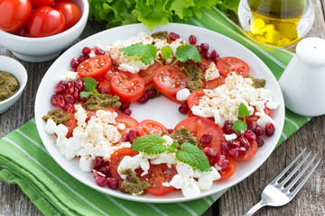 fresh salad with tomatoes, cottage cheese, mint pesto