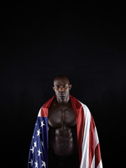 Muscular man wrapped in the American flag