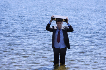 Businessman emerging from a reservoir to save your business