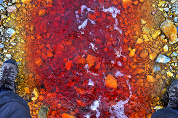 Red polluted water stream in Geamana, Romania