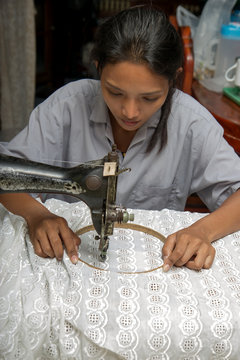 Asian Woman Using A Sewing Machine