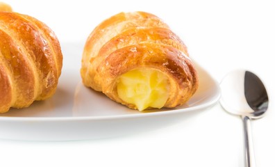 delicious cannoli filled with cream near a spoon