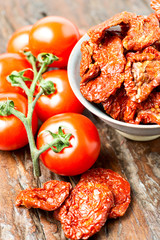 Set of dry and fresh tomatoes on wooden table top angle