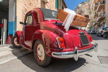 Red convertible retro car with case