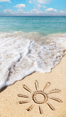 Sun drawn on the beach sand.
