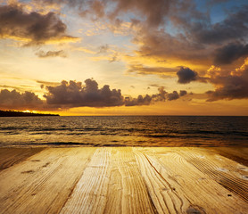 Fototapeta na wymiar Old wooden table with sea scene in background