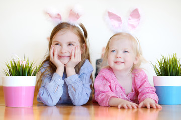 Two sisters wearing bunny ears on Easter