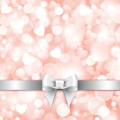 Shiny pink background with gift silver bow