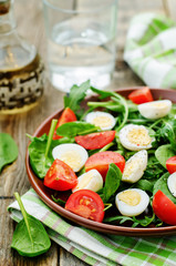 salad with arugula, spinach, tomatoes and eggs