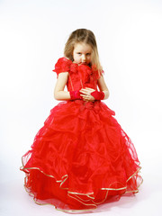 Cute little princess dressed in red dancing. Isolated on white b