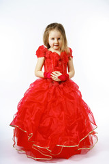 Cute little princess dressed in red dancing. Isolated on white b